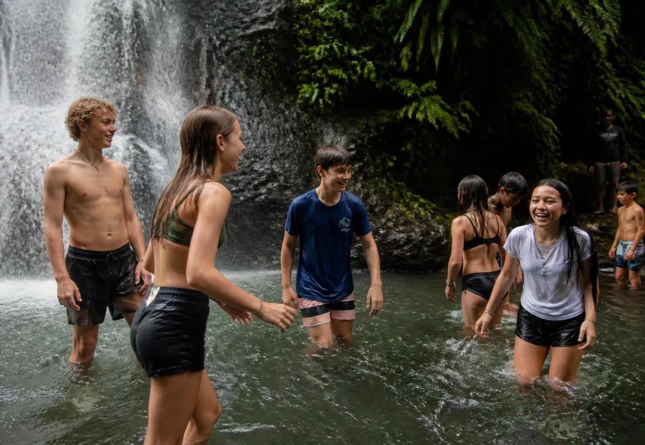 Children exploring a Bali waterfall during after-school care at Winta's Place